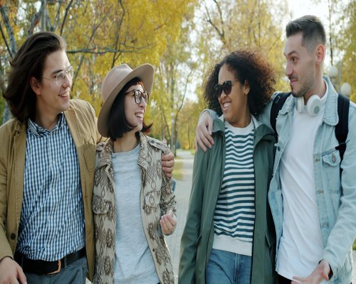 Group of friends talking while walking in nature