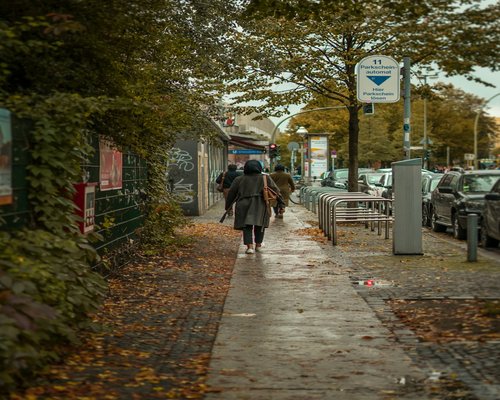 Woman enjoying a brisk walk in autumn weather on a city street
